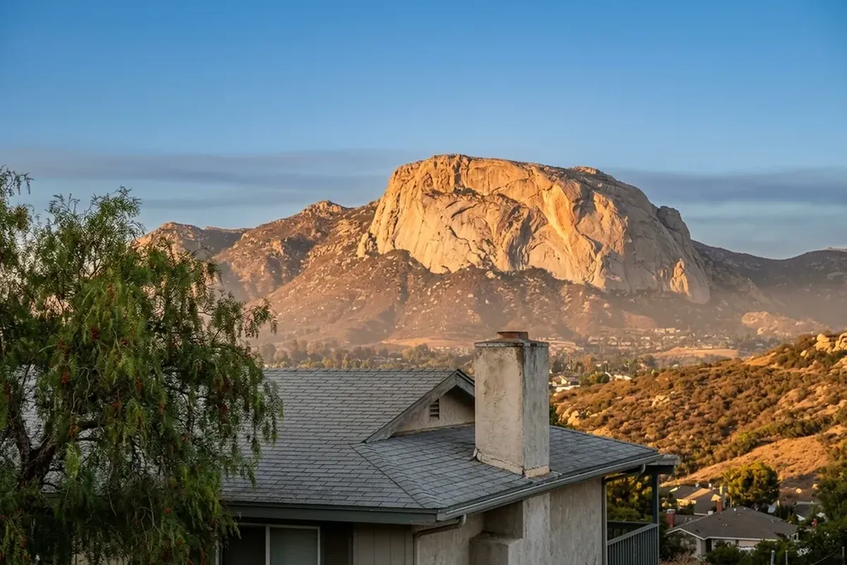 El Cajon Mountain, El Capitan, from Granite Hills at golden hour with a ranch-house roofline in the foreground